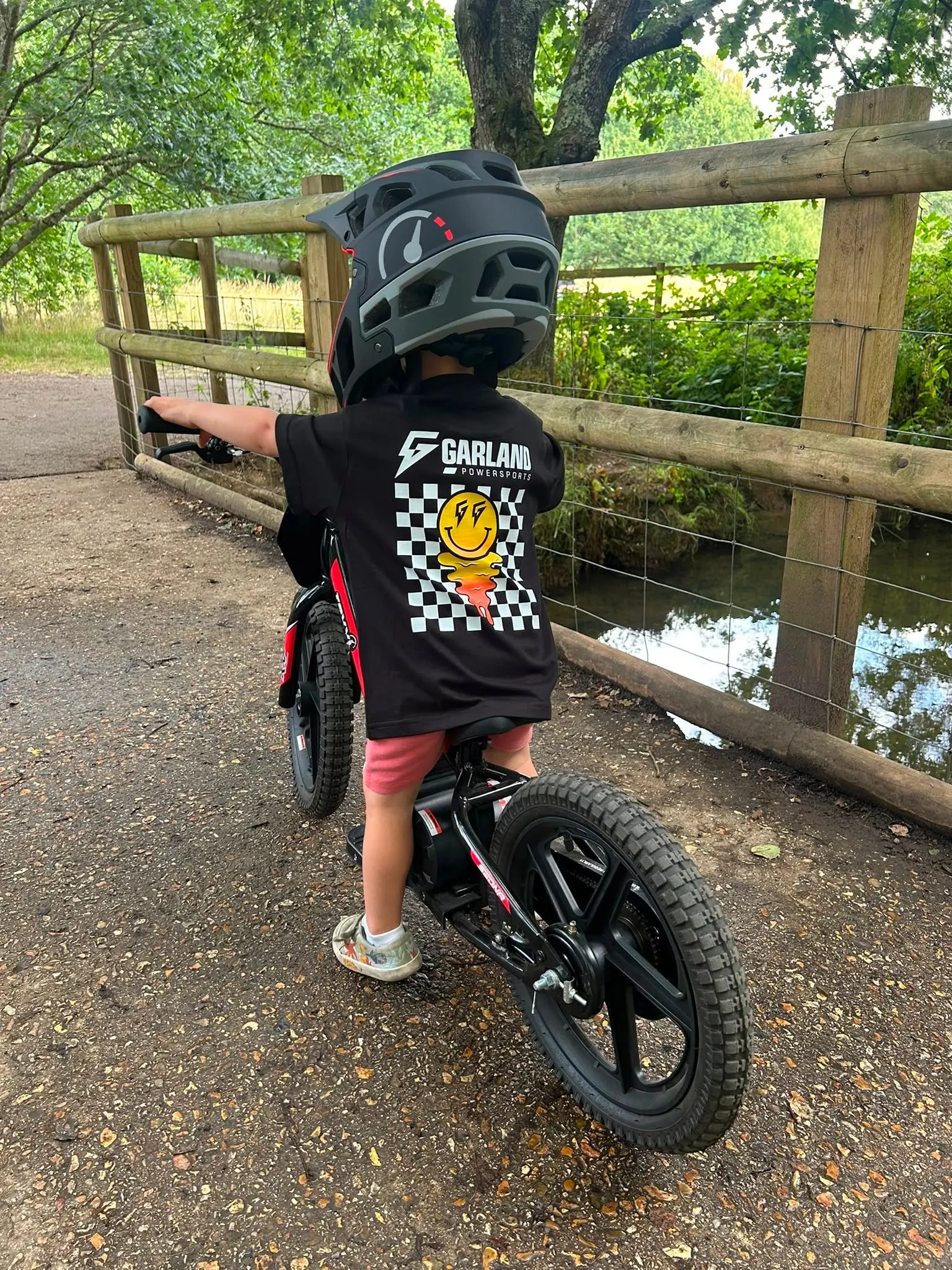 Young rider on a kids electric bike off road